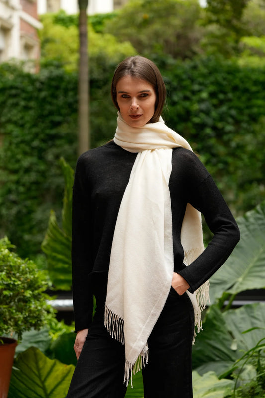 Woman wearing a white scarf in a garden setting